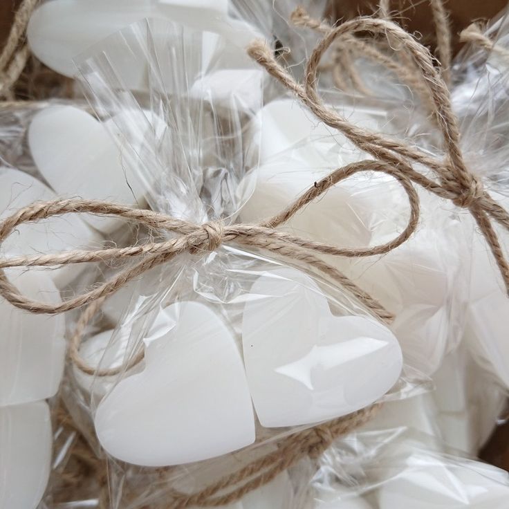 white heart shaped candles wrapped in plastic and rope