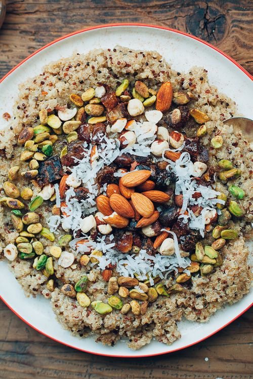 a white plate topped with oatmeal and nuts