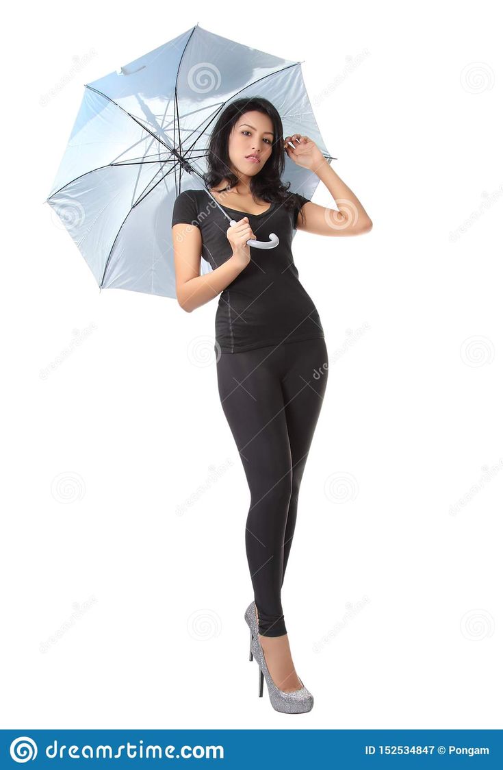 a woman holding an umbrella in her hand and posing for the camera on a white background