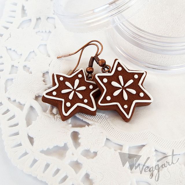 two star shaped wooden earrings on a doily