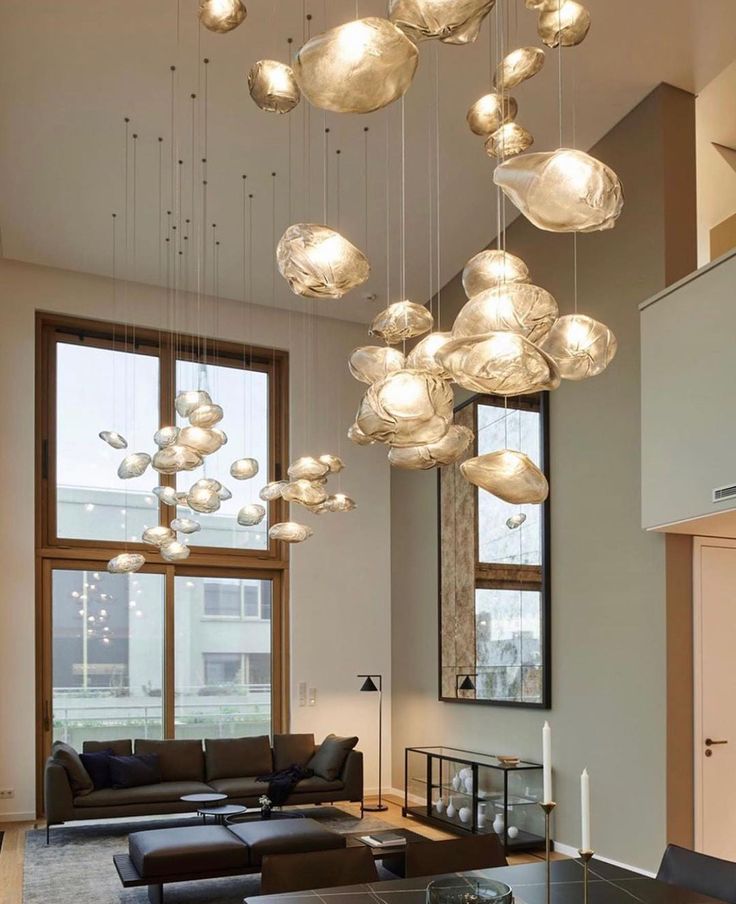 a living room filled with furniture and lots of lights hanging from it's ceiling