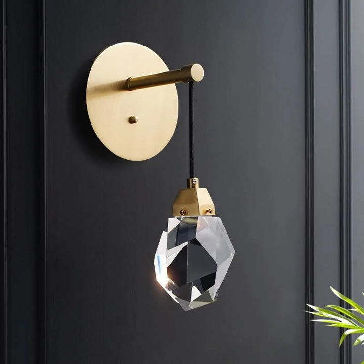 a black door with a gold handle and a crystal ball hanging from it's side