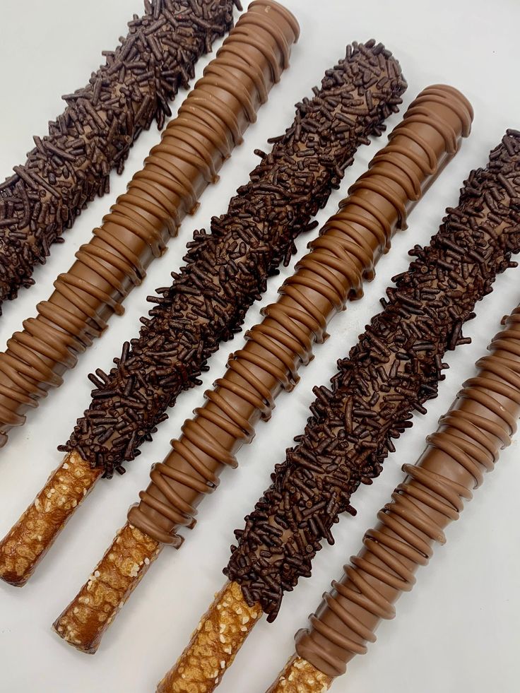 four pieces of chocolate and caramel covered candy sticks