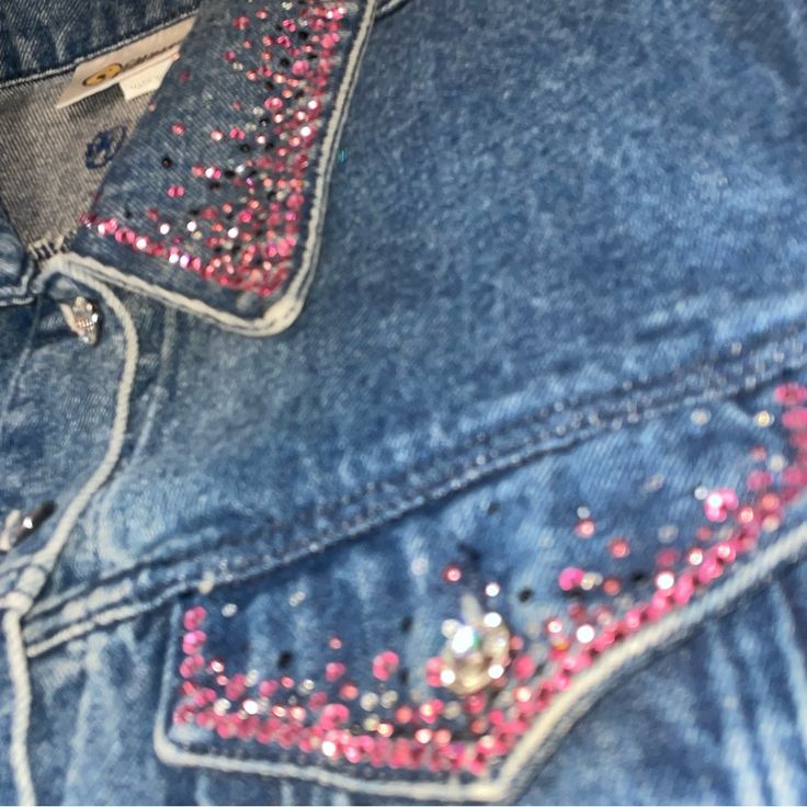 a pair of jeans with pink sequins on them