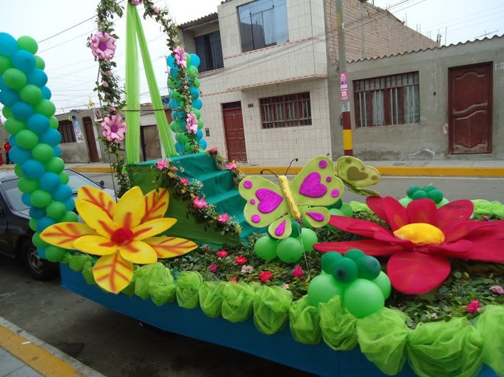 a float decorated with flowers, butterflies and balloons