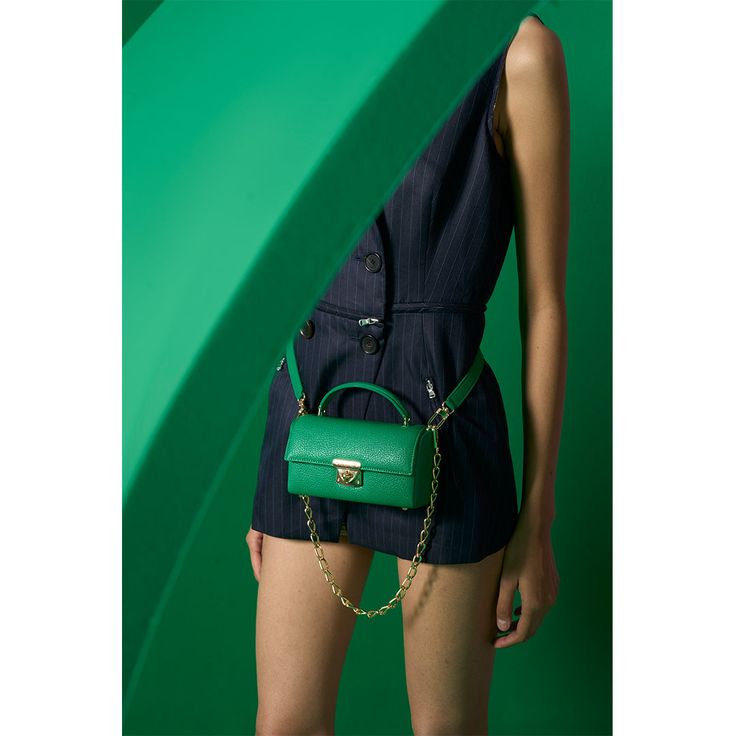 GREEN LEATHER MINI BAG WITH MIRROR AND GOLD CHAIN DETAIL Style this bag in 4 different ways to complement any outfit! Transition seamlessly from day to night by wearing it as a cross-body, shoulder bag, belt bag, or clutch. Create a unique look to match your outfit! Designed in NYC, Made in Italy. Material Vegetable-Tanned Leather sustainably made in Italy. The leather is tanned the natural way using plant extracts and no harsh chemicals. By repurposing byproducts from the meat industry, we are Green Satchel With Mobile Phone Bag For Evening, Chic Green Satchel With Mobile Phone Bag, Elegant Green Shoulder Bag With Chain Strap, Chic Green Shoulder Bag With Mobile Phone Holder, Green Crossbody Satchel For Party, Green Bag With Removable Pouch For Work, Green Top Handle Shoulder Bag With Chain Strap, Green Shoulder Bag With Chain Strap For Travel, Green Satchel With Gold-tone Hardware For Work