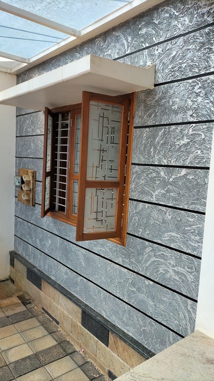 a window on the side of a house with tile flooring and wall coverings