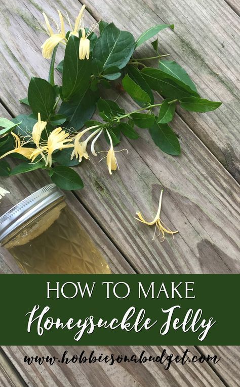 a mason jar filled with honeysuckle jelly next to flowers on a wooden table