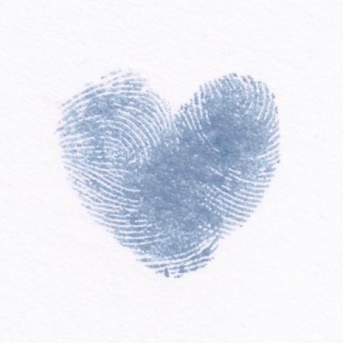 a fingerprint in the shape of a heart on a white paper with blue ink