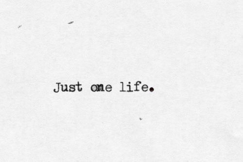 the words just one life written in black ink on a white paper with tiny dots