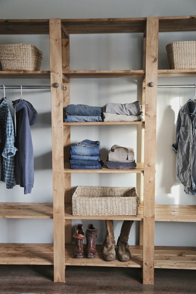 an image of a closet with clothes on shelves