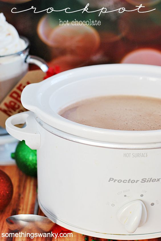 a crock pot filled with hot chocolate sitting on top of a table