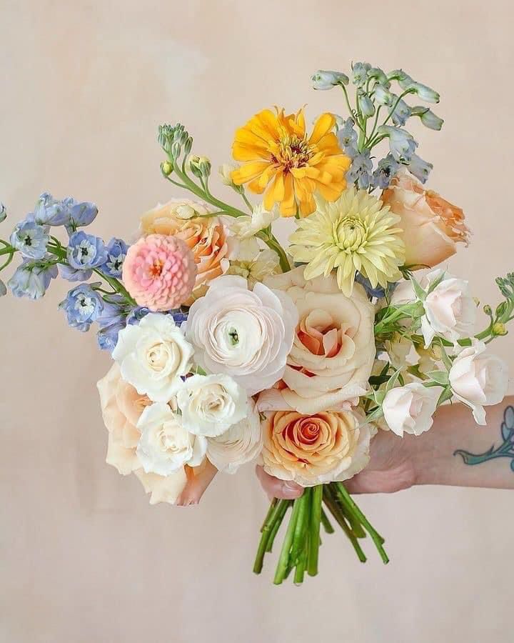 a person holding a bouquet of flowers in their hand