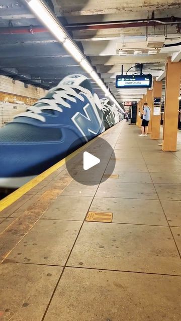 a blue train traveling through a subway station