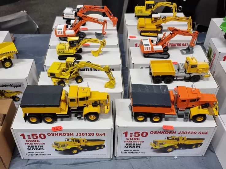 there are many toy trucks and construction vehicles on display