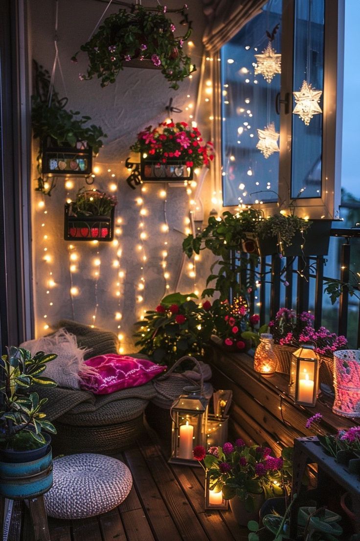 a balcony decorated with christmas lights and potted plants on the porch, lit by candles