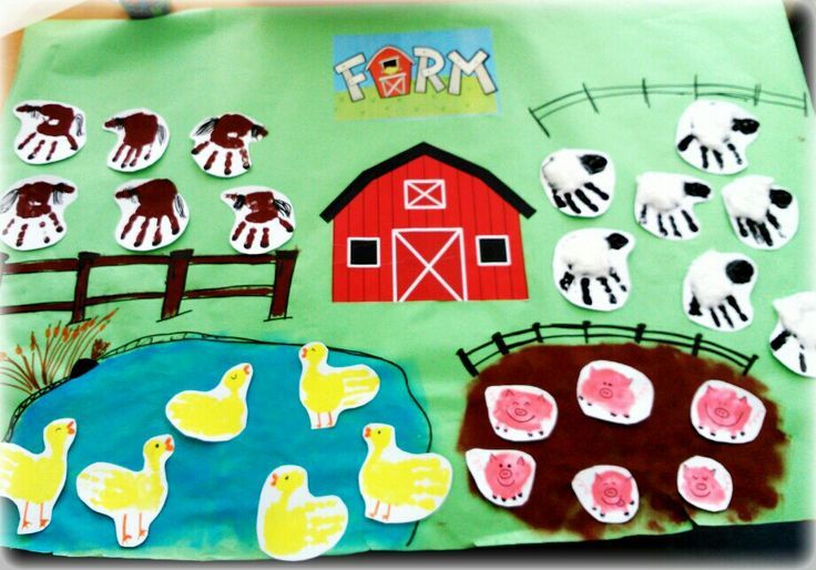 a paper bag with farm animals on it and sheep in the field next to a barn