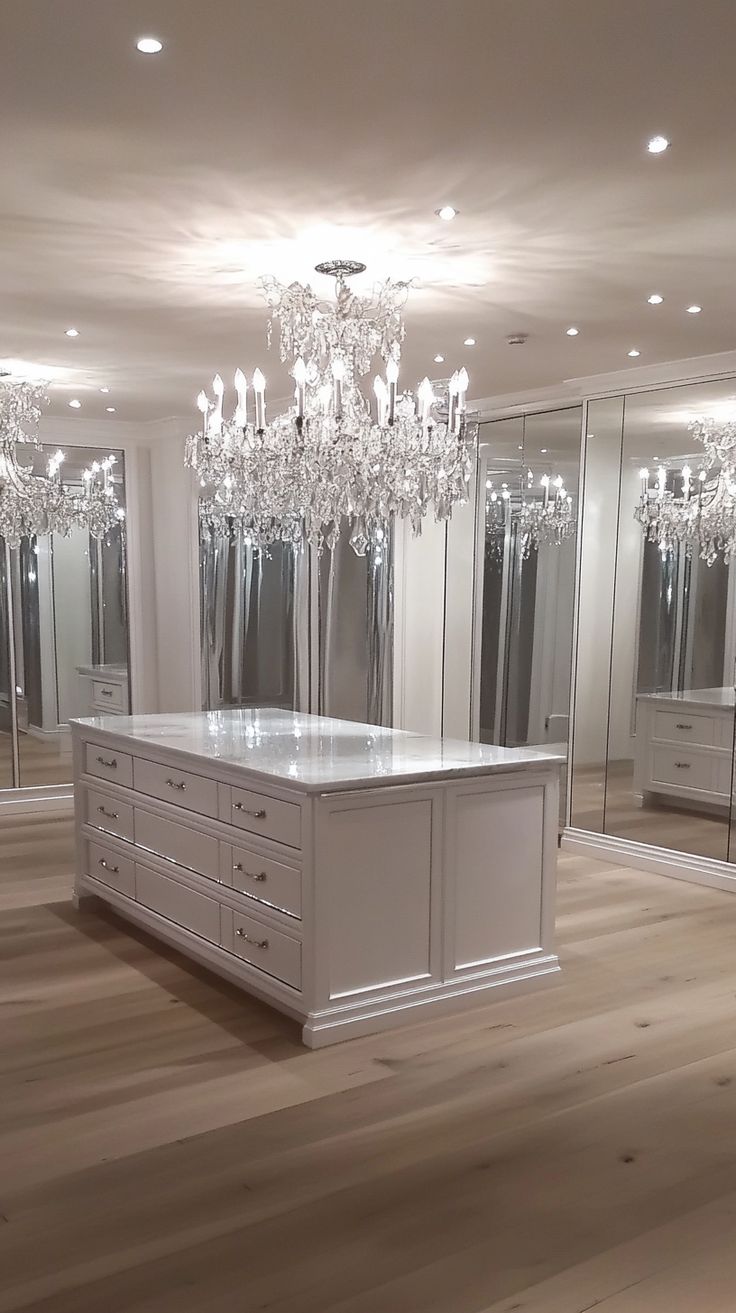 an empty room with mirrored closets and chandelier