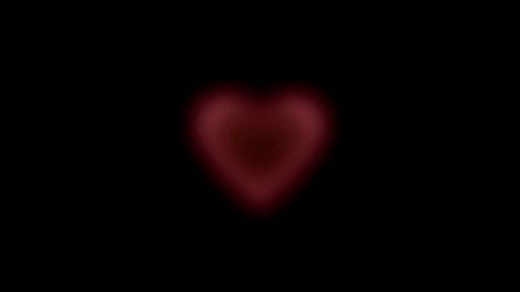 a heart shaped object in the dark with red light coming from it's center