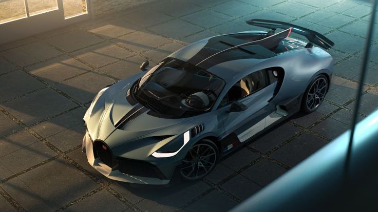 an aerial view of a sports car parked in a parking lot next to a building