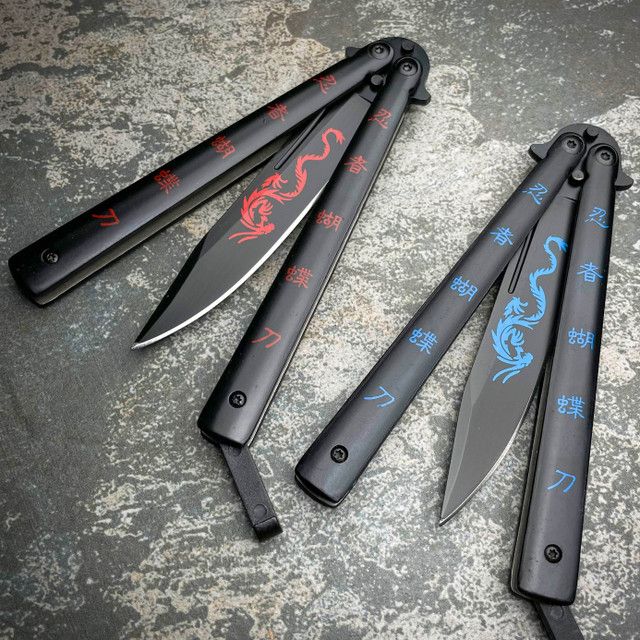 five knives with blue and red designs on them sitting on top of a stone surface