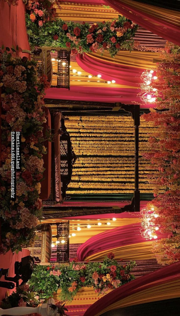 an aerial view of a building with lights and flowers on the balcony, taken from above