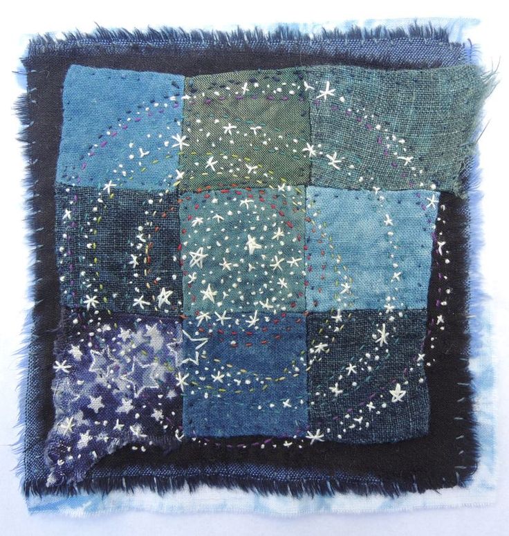 a blue and green patchwork square with stars on it