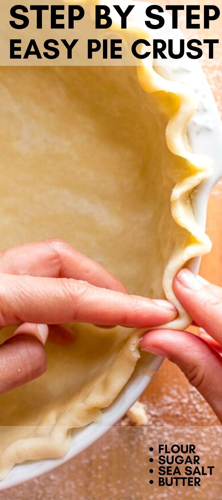 two hands are placing dough into a pie crust