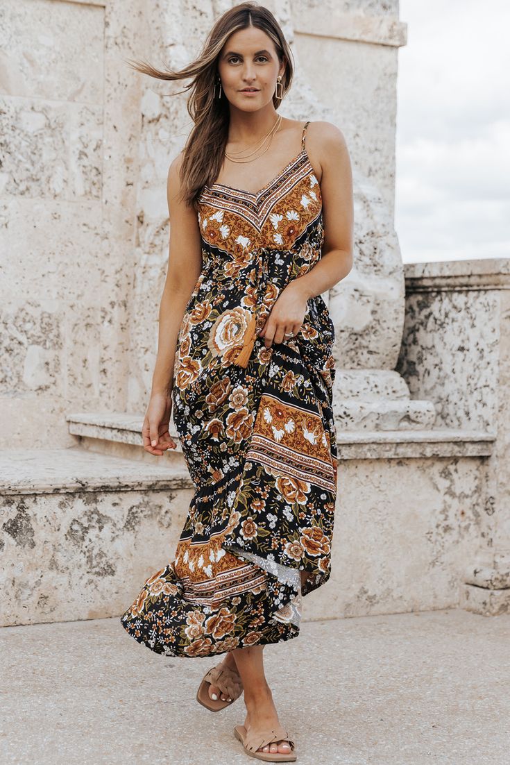 Black Retro Boho Floral Tassel Tie Maxi Dress Black Bohemian Dress With Boho Print, Black Flowy Boho Dress With Boho Print, Black Boho Print Dress For Festival, Black Boho Print Maxi Length Dress, Black Boho Print Maxi Dress For Vacation, Casual Black Dress With Tassels, Black Bohemian Midi Dress For Vacation, Bohemian Black Sleeveless Midi Dress, Black Sleeveless Bohemian Midi Dress