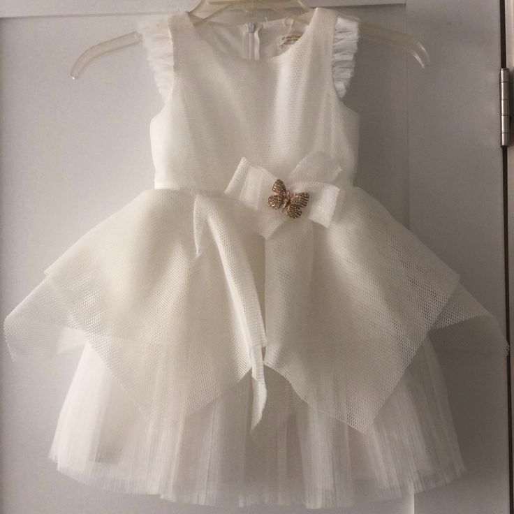 Perfect For Baptism Or Flower Girls. White Tulle And Flutter Detail On Sleeves. Butterfly Brooch On Waist. First Communion Tulle Dress With Ruffles, Tulle Dress With Flutter Sleeves For Dress-up, Tulle Baptism Dress With Bow, Elegant Summer Princess Dress For Confirmation, Spring Baptism Tutu Dress With Bow, Ruffled Tutu Dress For First Communion, Elegant Ruffled Tutu Dress For First Communion, Confirmation Tulle Princess Dress With Ruffles, Confirmation Princess Dress With Tulle Ruffles