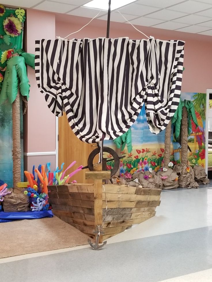 a classroom decorated with black and white striped drapes hanging over the top of a boat