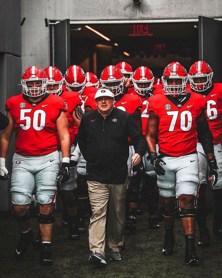 the football team is walking out onto the field