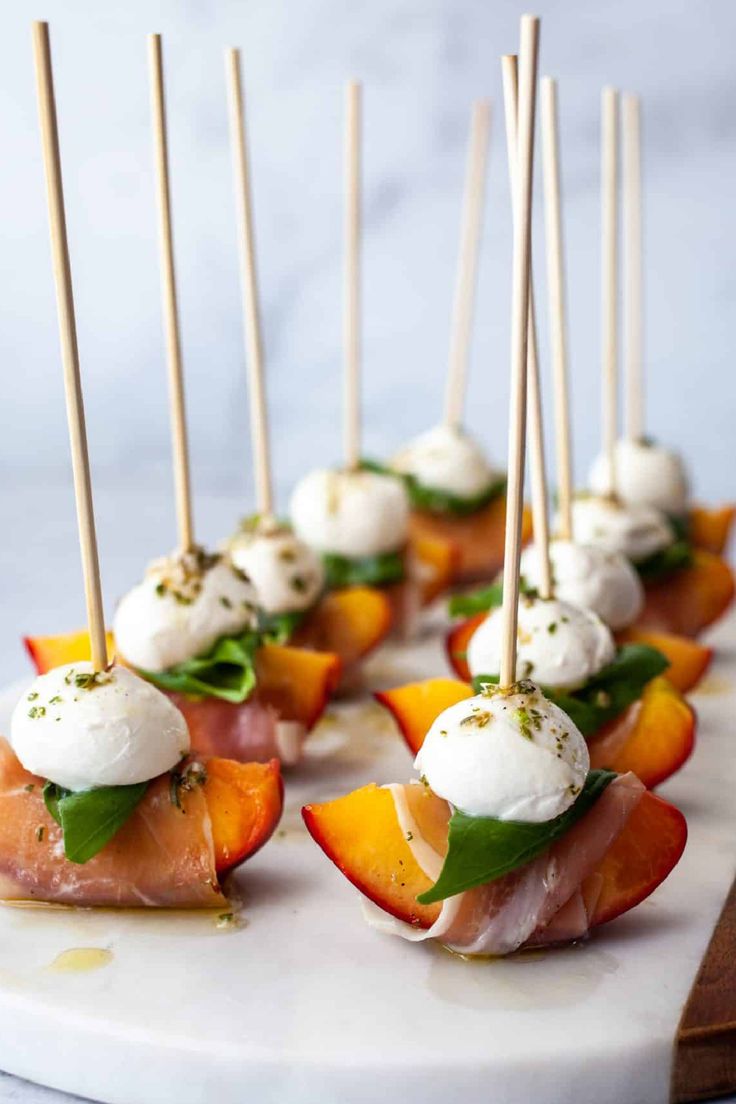 small appetizers are arranged on a platter with toothpicks in them