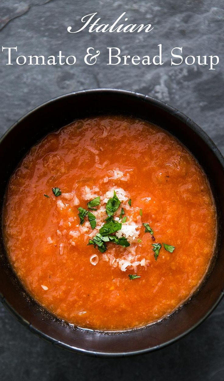 tomato and bread soup in a black bowl