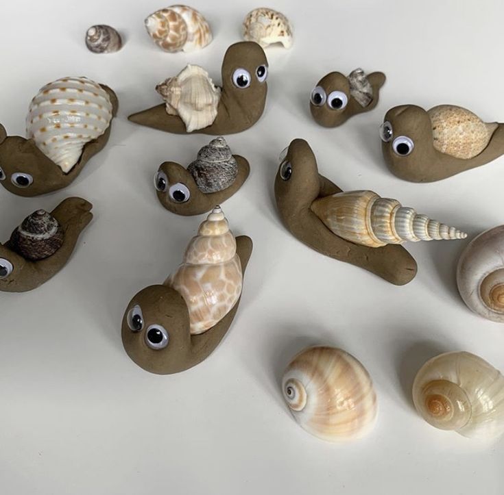 there are many sea animals made out of rocks and seashells on the table