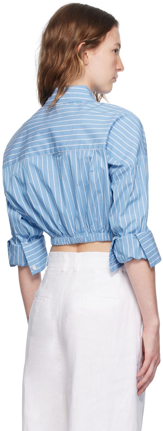 Stretch cotton poplin shirt. Pinstripes throughout. · Spread collar · Concealed button closure · Self-tie straps at partially elasticized cropped hem · Dropped shoulders · Rolled elasticized cuffs · Locker loop at back yoke Supplier color: Azure pinstripe Spring Daywear Top With Striped Cuffs, Spring Daywear Tops With Striped Cuffs, Fitted Cotton Tops By Staud, Casual Spring Tops By Staud, Spring Casual Staud Tops, Casual Staud Tops For Spring, Casual Tops With Striped Cuffs For Daywear, Summer Cotton Tops By Staud, Staud Cotton Tops For Spring