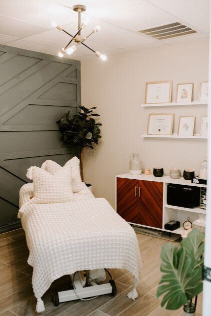 a white bed sitting in a bedroom next to a wall