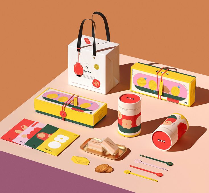 an assortment of items on a table including a tote bag, pencils and matches