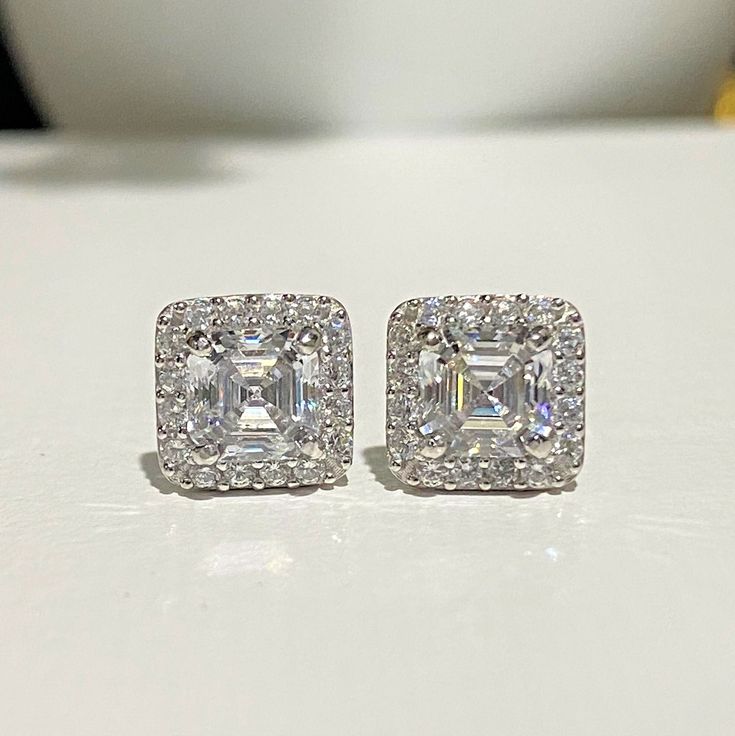 Vintage 14K Solid White Gold White Sapphire Earrings...Marked 14K...Total of weights 1.4grams...Measure of Face 7.6MM...With 02 Asscher White Sapphire 5MM 0.71ct EachThese are in very good condition. Classic Diamond Cut Bridal Earrings For Evening, Timeless Cubic Zirconia Bridal Earrings For Anniversary, Luxury Earrings With Halo Setting For Gift, Timeless 14k White Gold Wedding Earrings, Anniversary Sterling Silver Diamond Cut Cluster Earrings, Anniversary Diamond Cut Sterling Silver Cluster Earrings, Timeless Silver Diamond Earrings For Anniversary, Timeless Diamond Cut Earrings For Formal Occasions, Elegant Cluster Earrings With Halo Setting For Anniversary