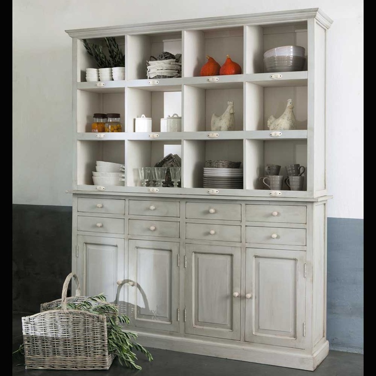 a white china cabinet with lots of dishes on it