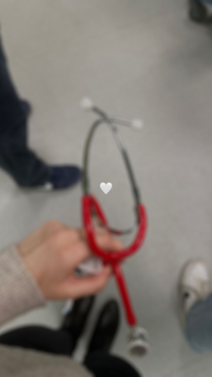 a person holding a stethoscope with a heart on it