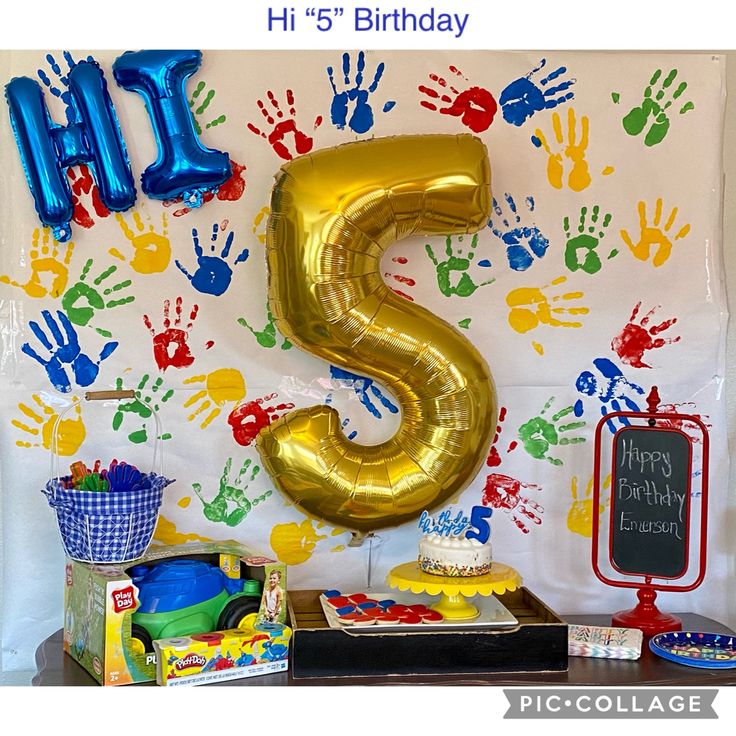 a birthday party with handprints and balloons