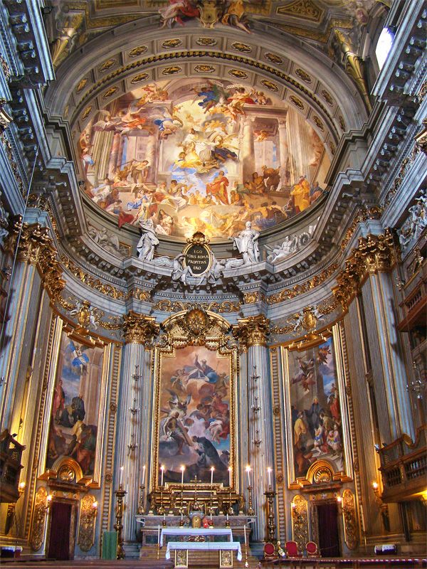 the interior of an ornate church with paintings on the walls