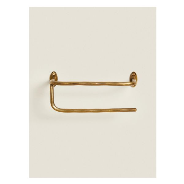 an antique brass towel ring on a white background