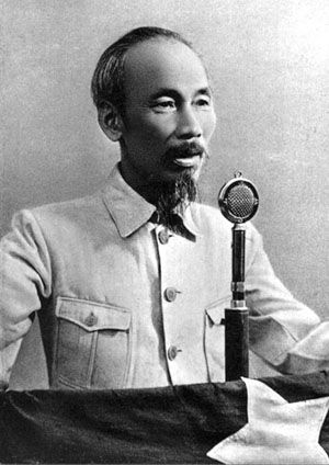 an old photo of a man holding a microphone