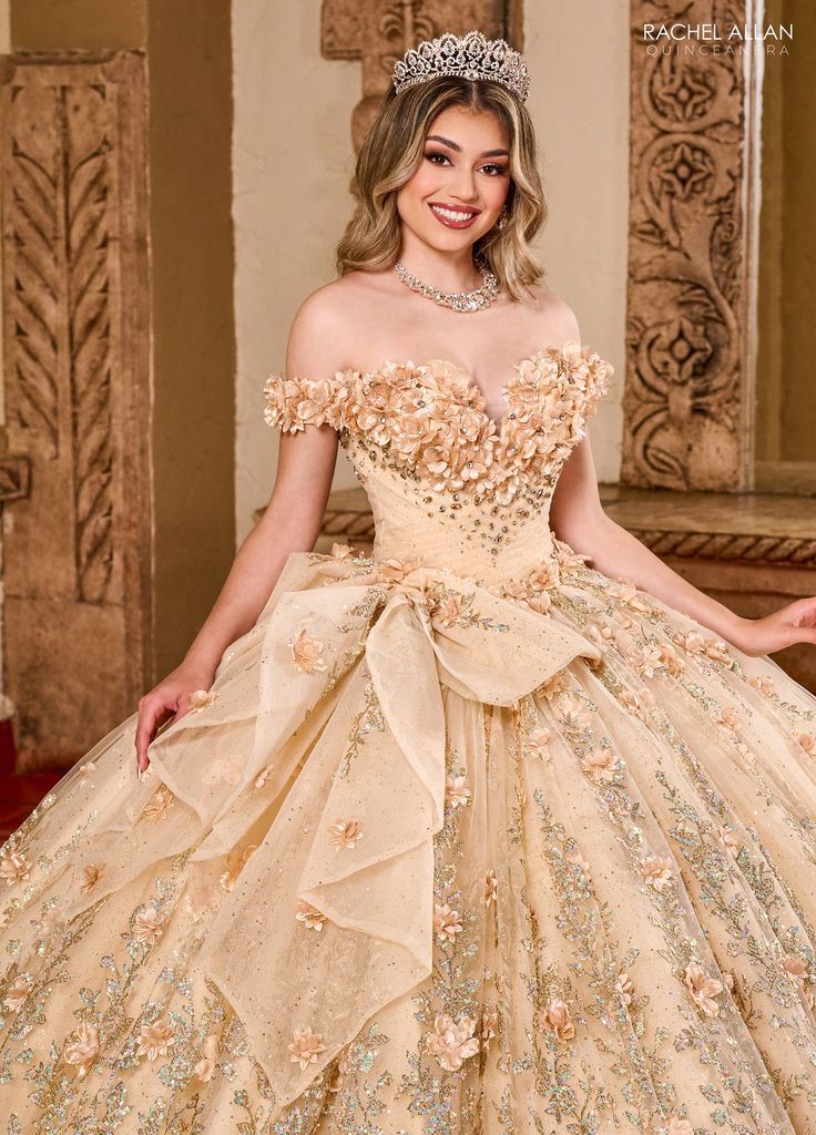 Receive lots of compliments in this 3D floral applique long off the shoulder dress with A-line skirt by Rachel Allan RQ1141. From top to bottom this gown is a masterpiece of opulent design, perfect for a grand celebration. The off-the-shoulder neckline and fitted bodice are intricately adorned with tonal floral appliqués and shimmering beads that enhance the gown’s luxurious feel. The full skirt extends into a majestic sweep of layered tulle, richly embellished with floral motifs and sparkling a Dama Dresses Quinceanera, Long Off The Shoulder Dress, Detachable Puff Sleeves, 1500 Dresses, Dama Dresses, Military Ball Dresses, Diy Wedding Dress, Champagne Dress, Theme Dress