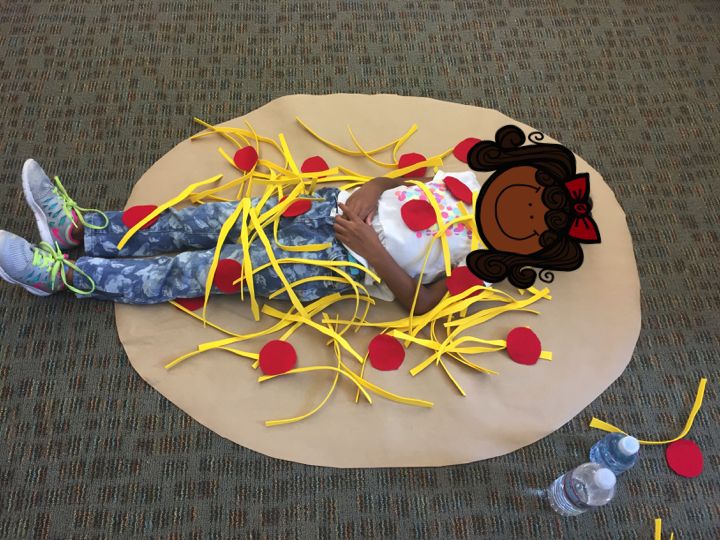 a child is laying on the floor next to some decorations