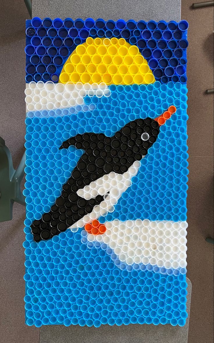 Tip: After deciding on a design, paint simple background colours on your board to give the finished piece more pop! Kids Recycling Projects, Bottle Crafts For Kids, Plastic Bottle Cap Crafts, Bottle Top Art, Bottle Top Crafts, Bottle Cap Projects, Kids Painting Party, Recycling Projects, Penguin Crafts