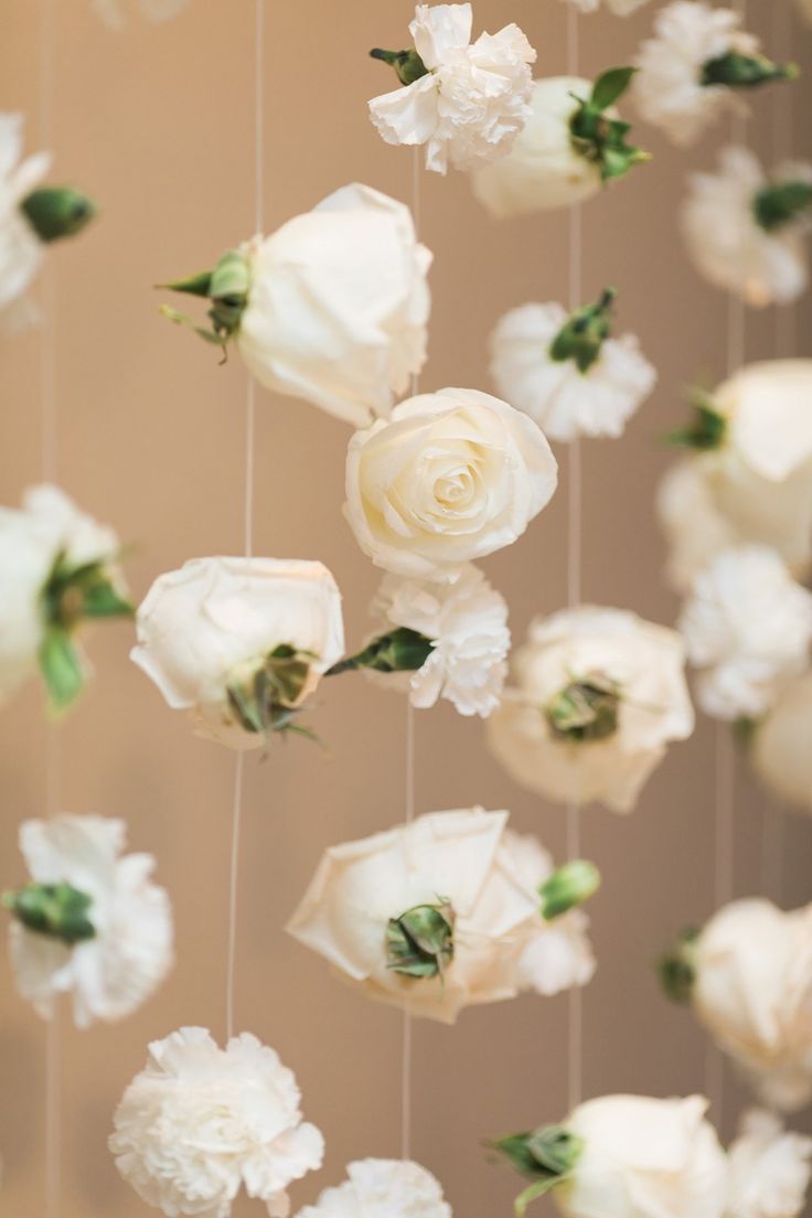 white flowers are hanging from the ceiling