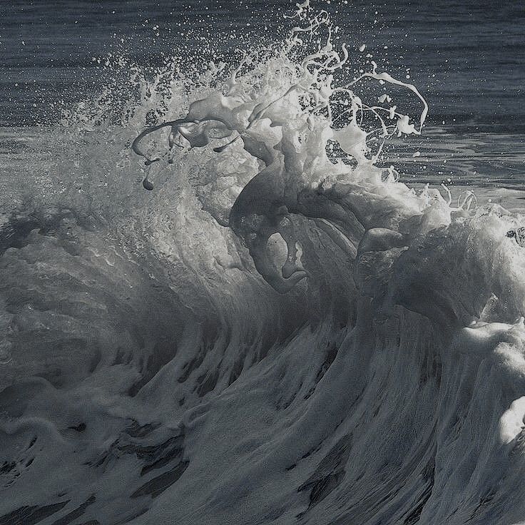 an ocean wave with white and orange paint on it